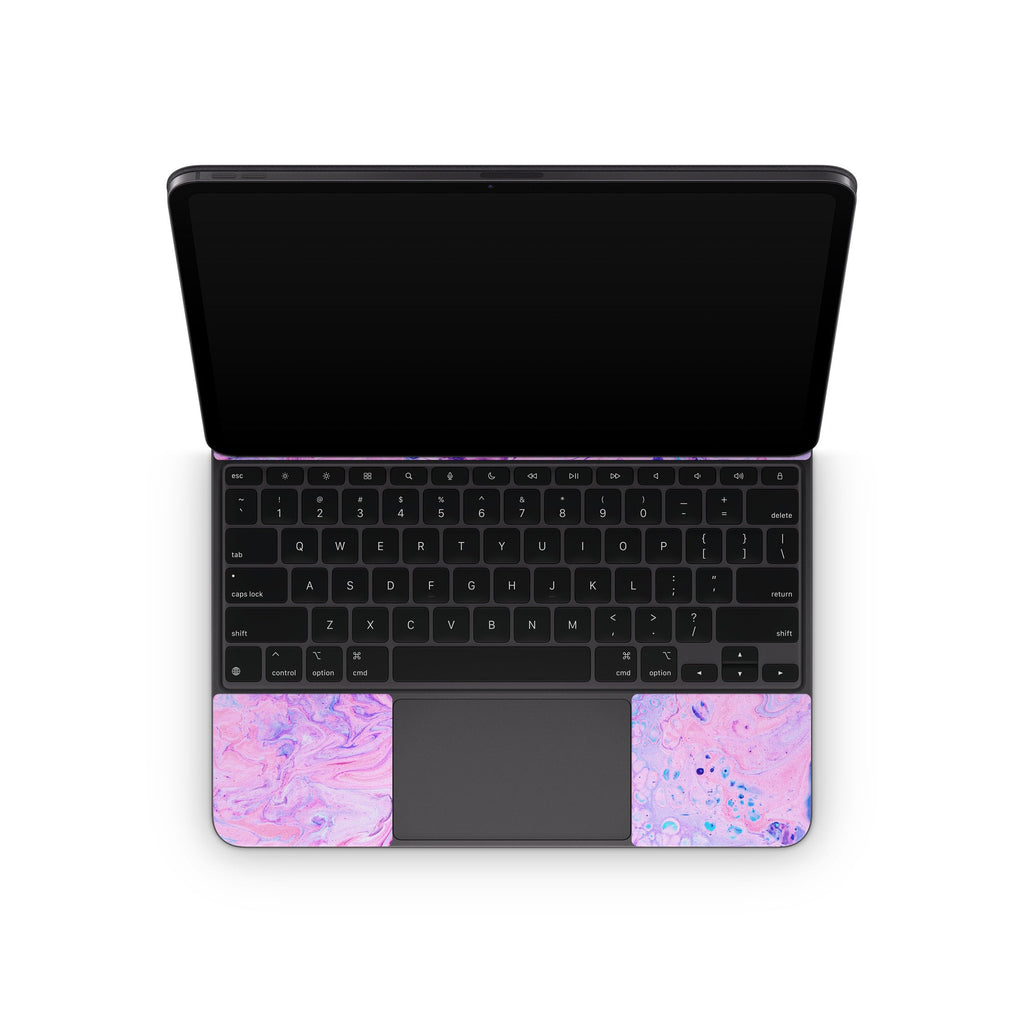 Apple Magic Keyboard iPad skin with purple-pink swirls on palm rests, open view