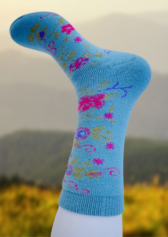 Light blue alpaca socks with multicolor geometric embroidery-style pattern