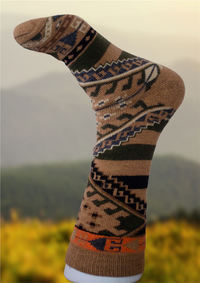 Tan alpaca sock with dark geometric and animal-like motif stripes