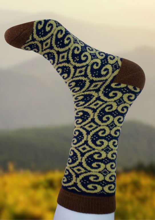 Alpaca socks with brown cuff and heel, blue swirling pattern, and yellow accents.