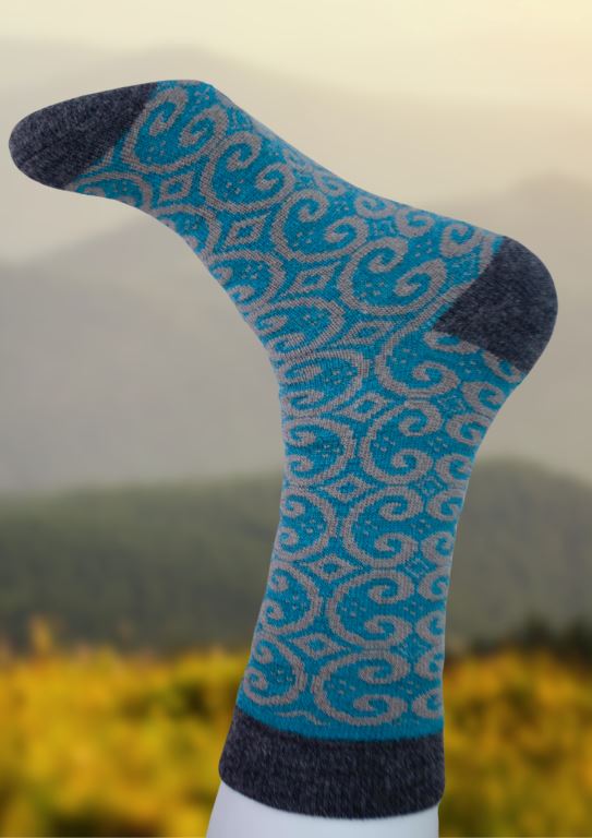 Alpaca socks in bright blue with navy swirl pattern and dark ribbed cuff.