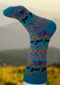 Alpaca socks in teal blue with multicolor geometric pattern, dark toe and heel.