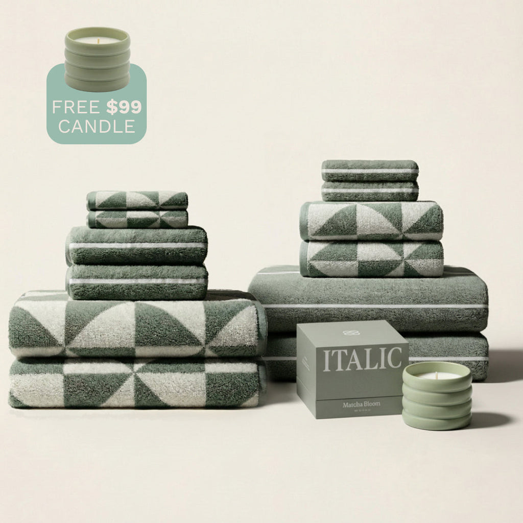 Cotton towel set with green and ecru geometric stripes, folded in coordinated stacks.