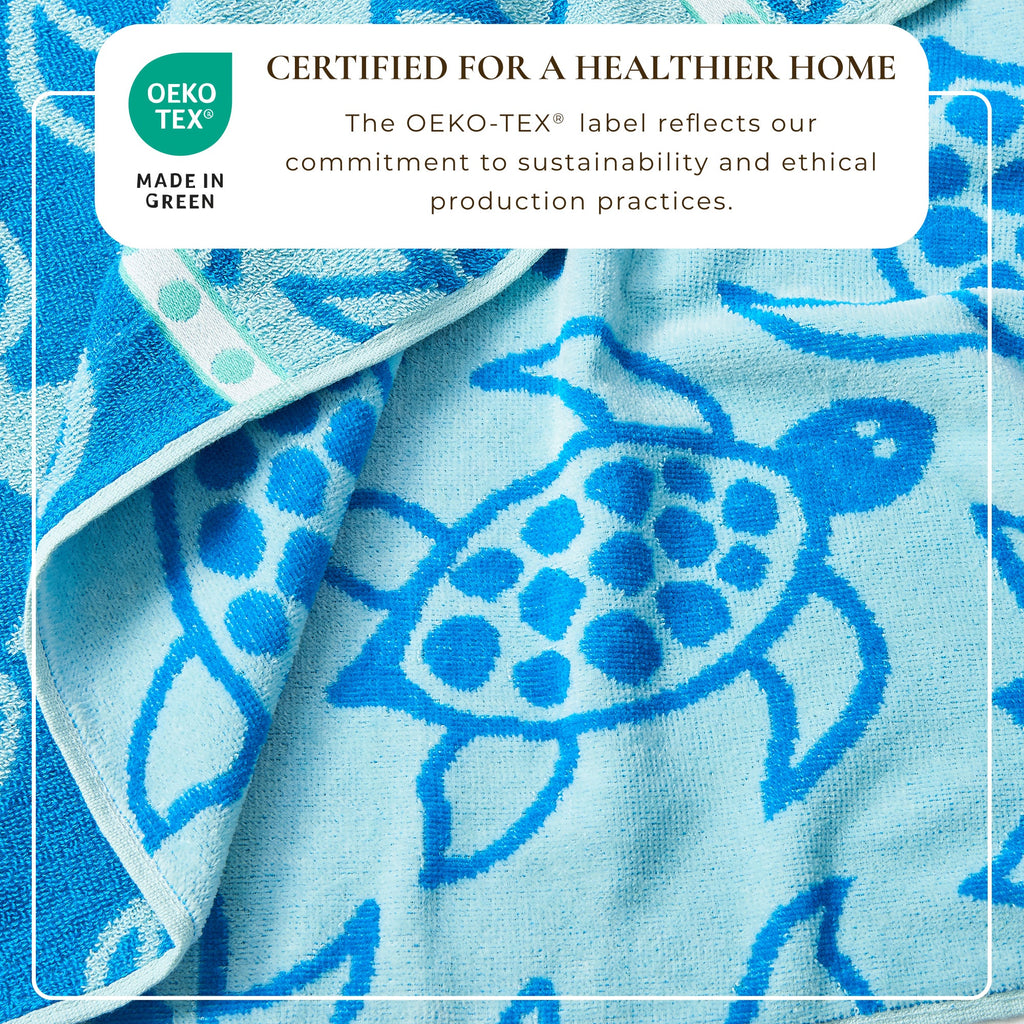 Blue cotton velour beach towel with detailed sea turtle medallion pattern.