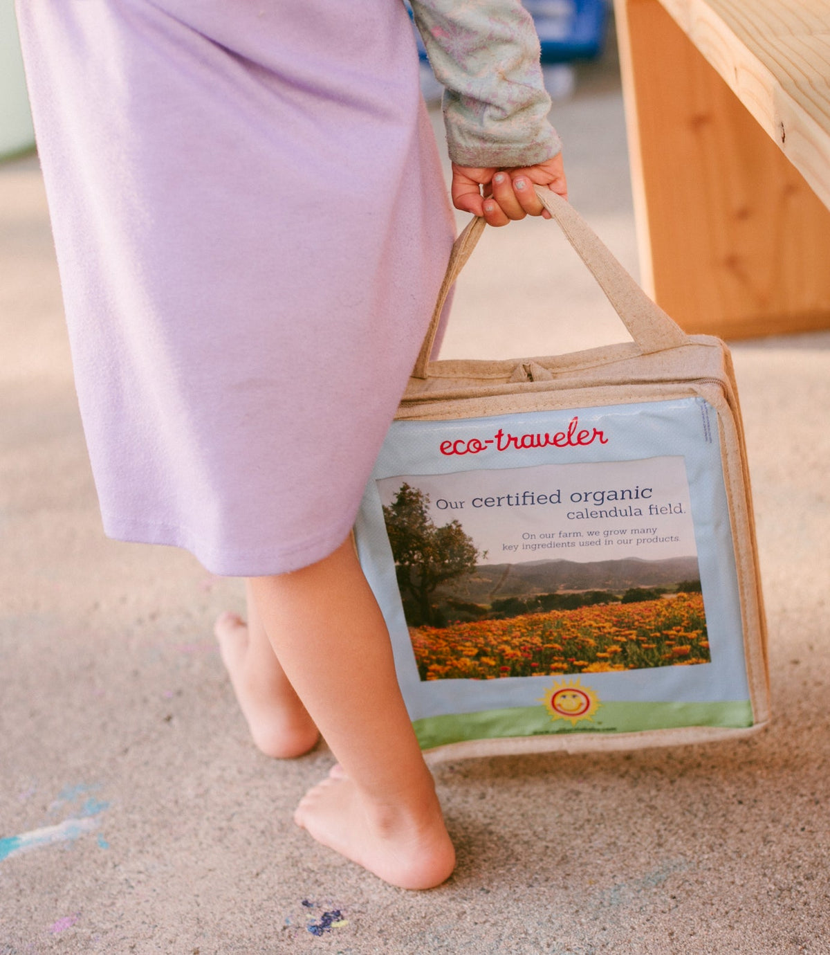 Plant-based deluxe travel set: eco-traveler pouch held by child