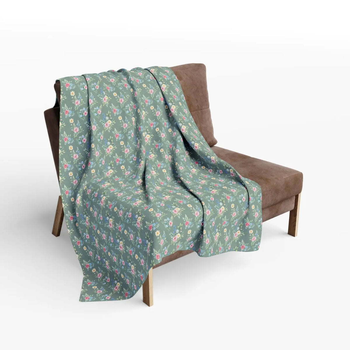Pastel floral fleece blanket draped over armchair, green fabric with pink and yellow blooms