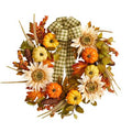 Artificial autumn wreath with plaid ribbon, sunflowers, pumpkins, and fall foliage