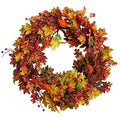 Artificial autumn wreath with oak leaves, berries, and small pumpkin accents
