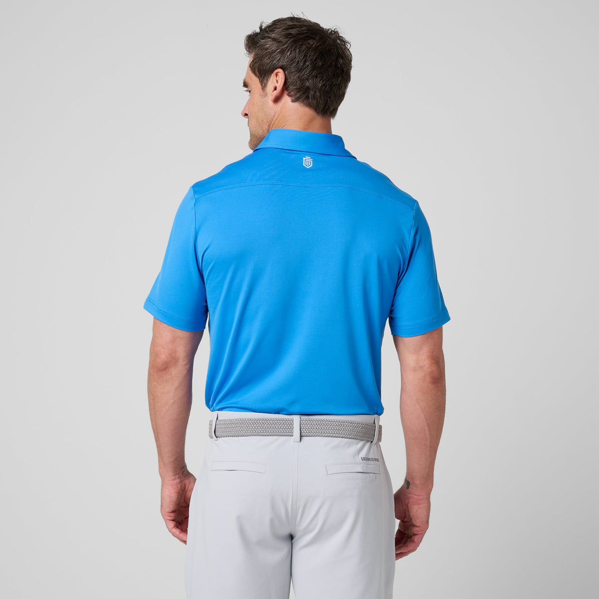Sonic blue polo shirt back view with collar and small shield logo