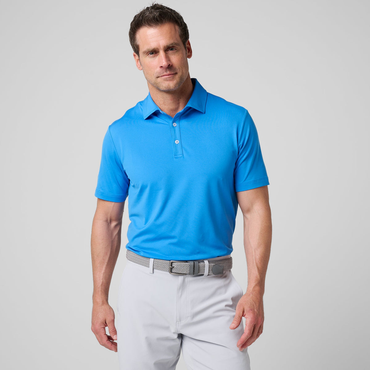 Sonic blue athletic tech polo shirt with short sleeves and button-front placket