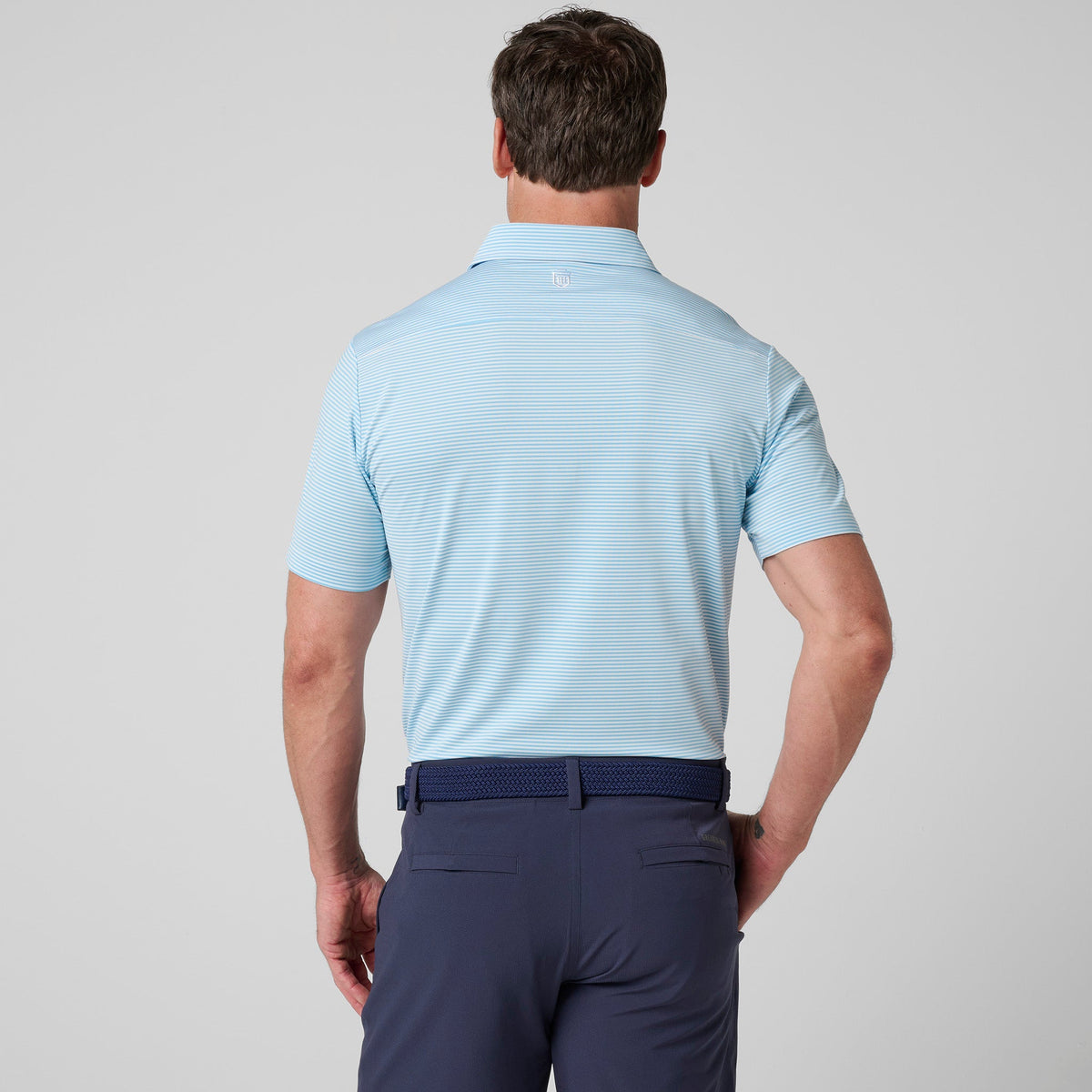 Back view of light blue striped polo shirt with buttoned neck placket