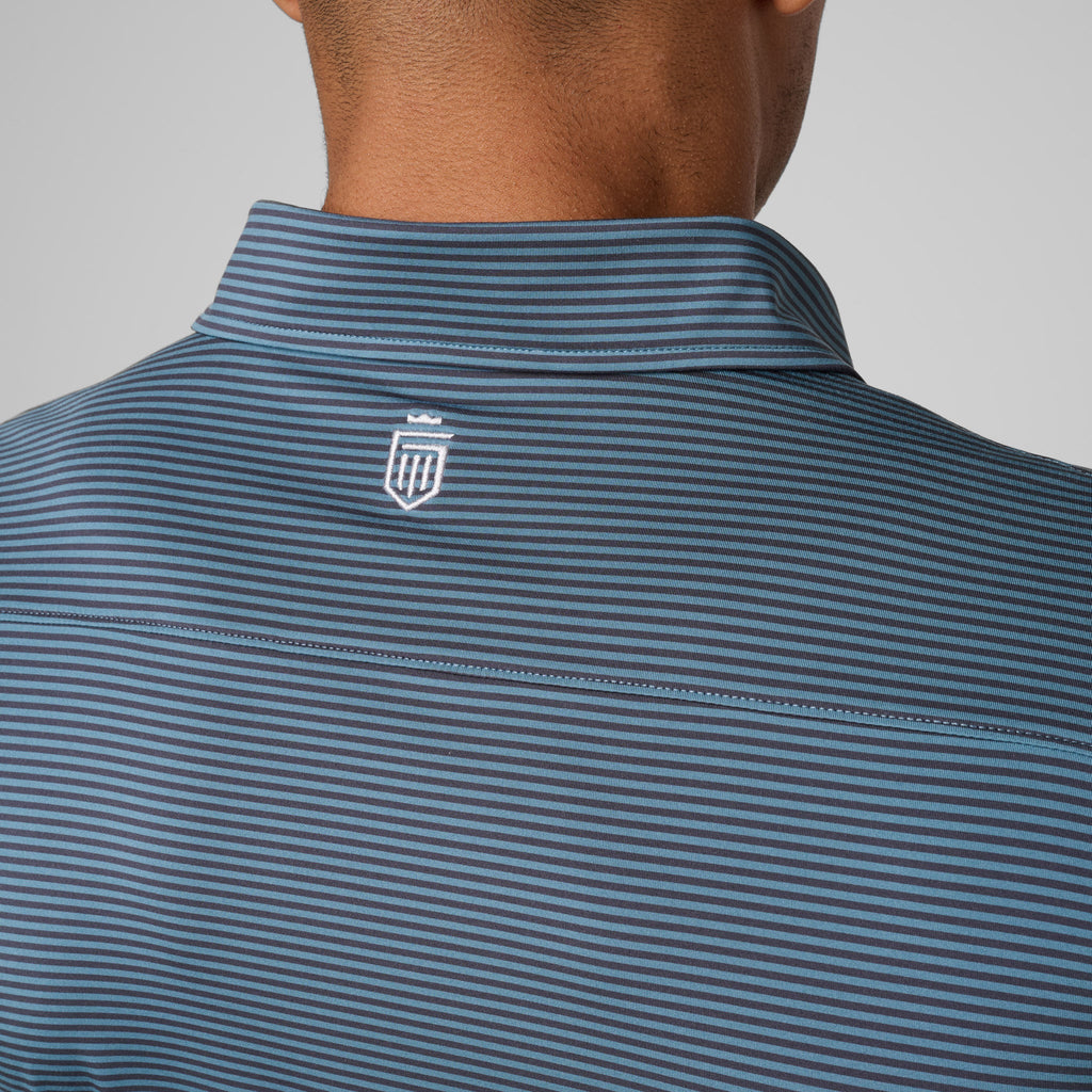 Athletic polo collar with blue stripes and small shield logo at back neck.