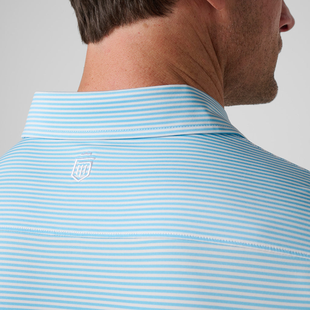 Light blue striped polo back with small shield logo near upper shoulder
