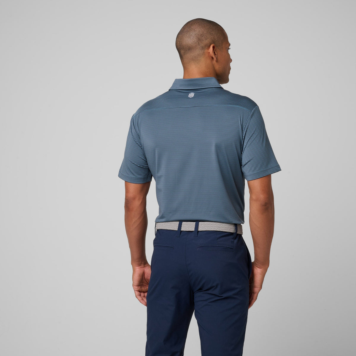 Men's striped athletic polo shirt, short sleeves, back view with buttoned collar.