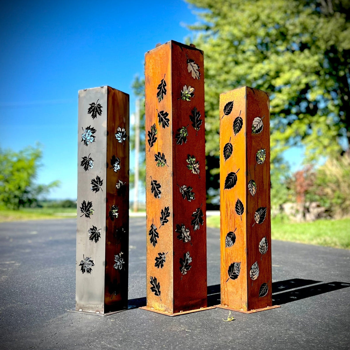 Rectangular solar pillar luminary set with leaf cutout designs on metal panels