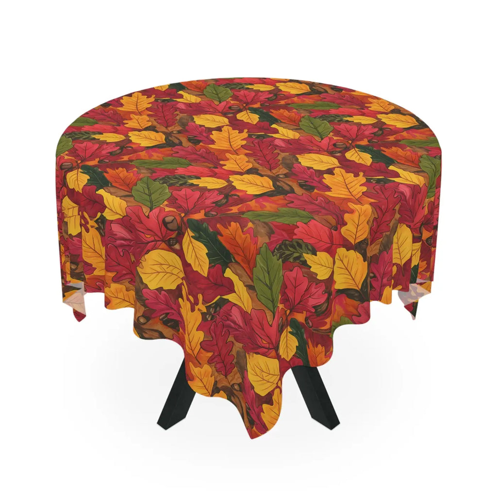 Draped autumn leaf-patterned tablecloth with red, yellow, and green foliage