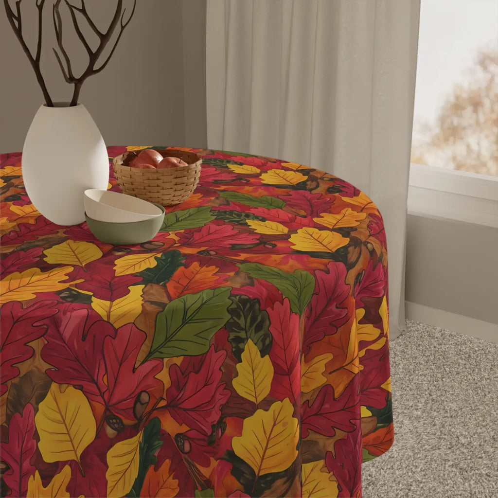 Autumn leaf-print tablecloth in red, yellow, and green on a dining table