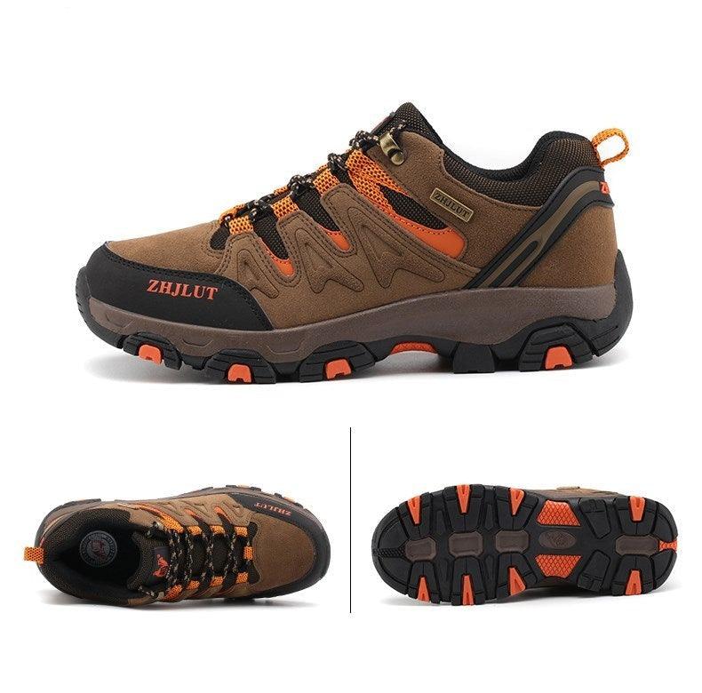 Low-top hiking shoes in brown with black and neon orange laces, grippy rubber outsole