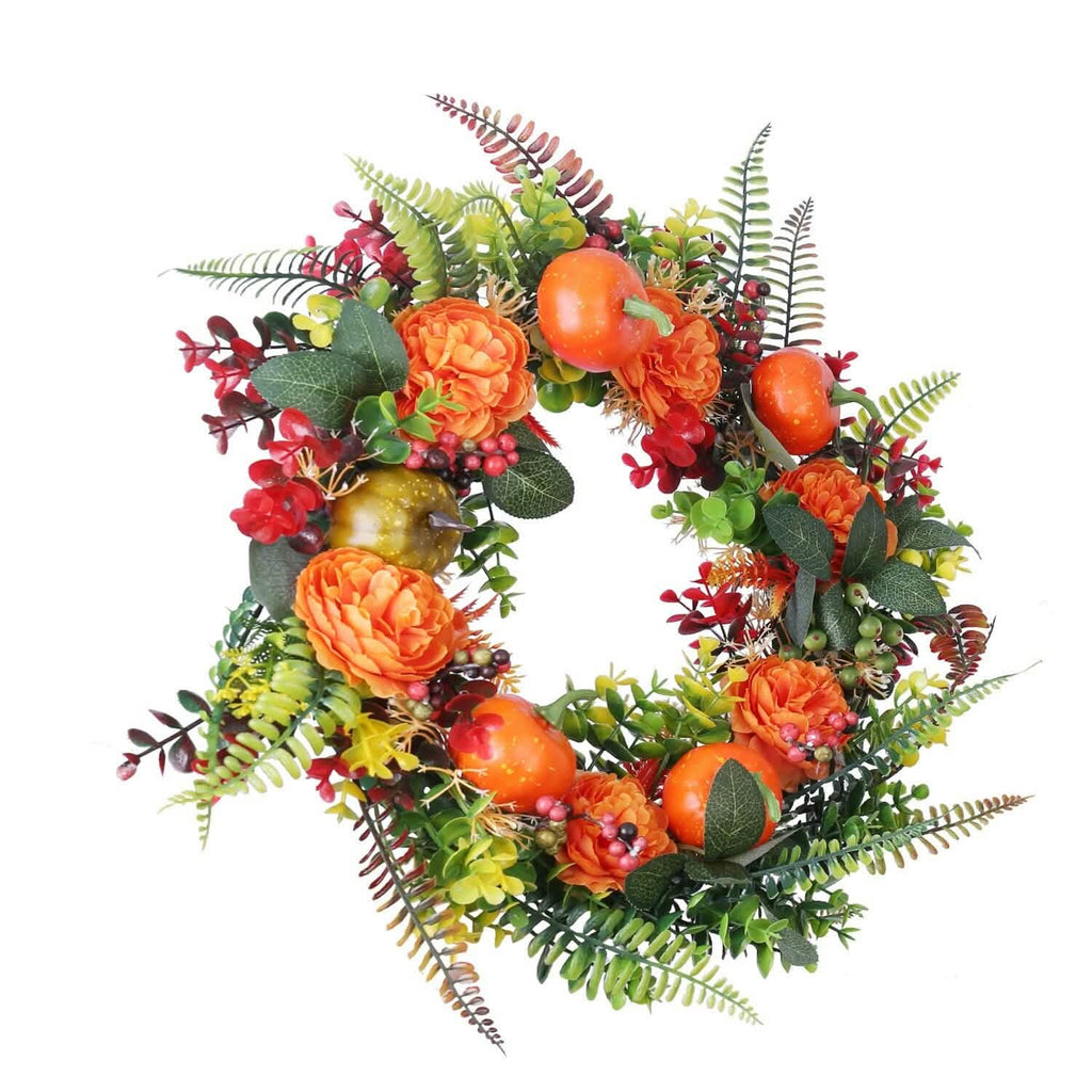 Autumn wreath with orange pumpkins, orange flowers, red berries, green eucalyptus-style leaves