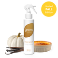 Air and fabric spray bottle with amber 'grow' label and small pumpkin and candle