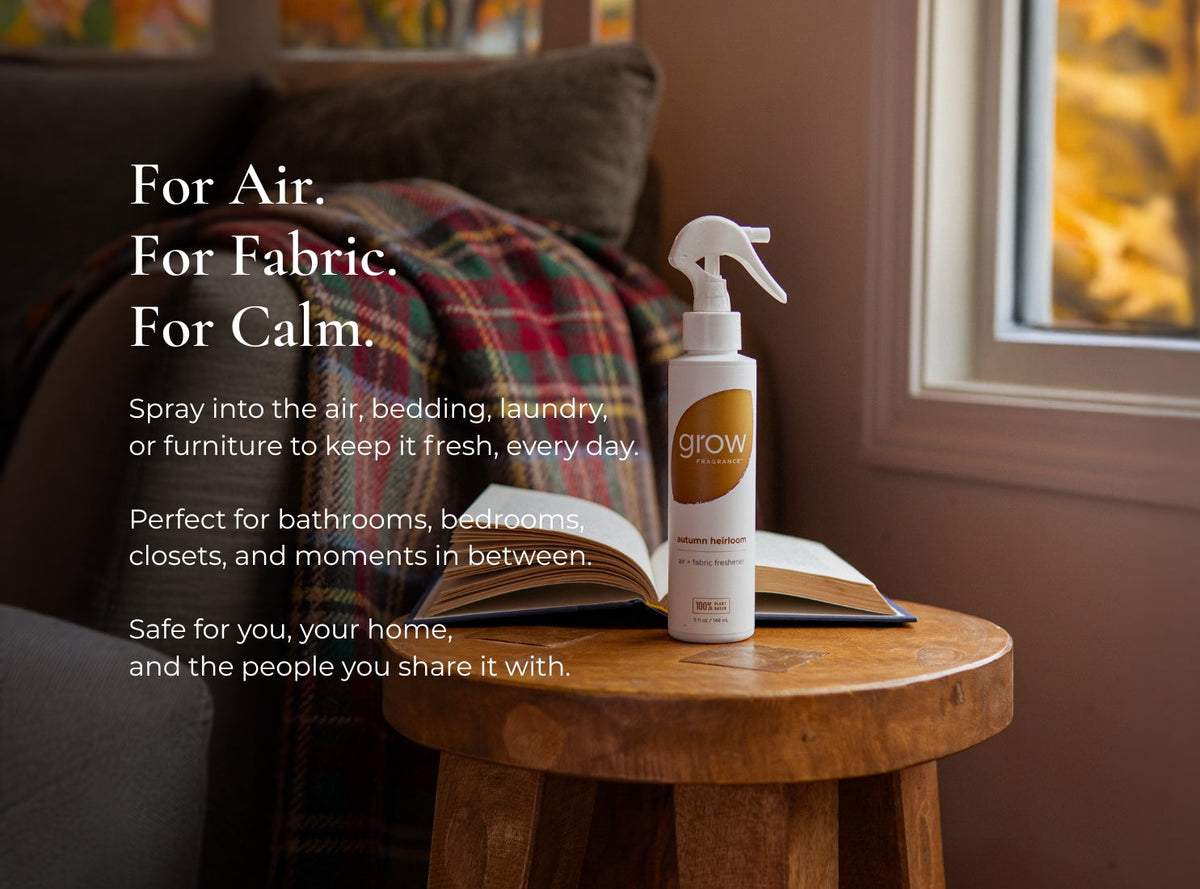 Air and fabric spray bottle with 'grow' logo on side table near plaid blanket