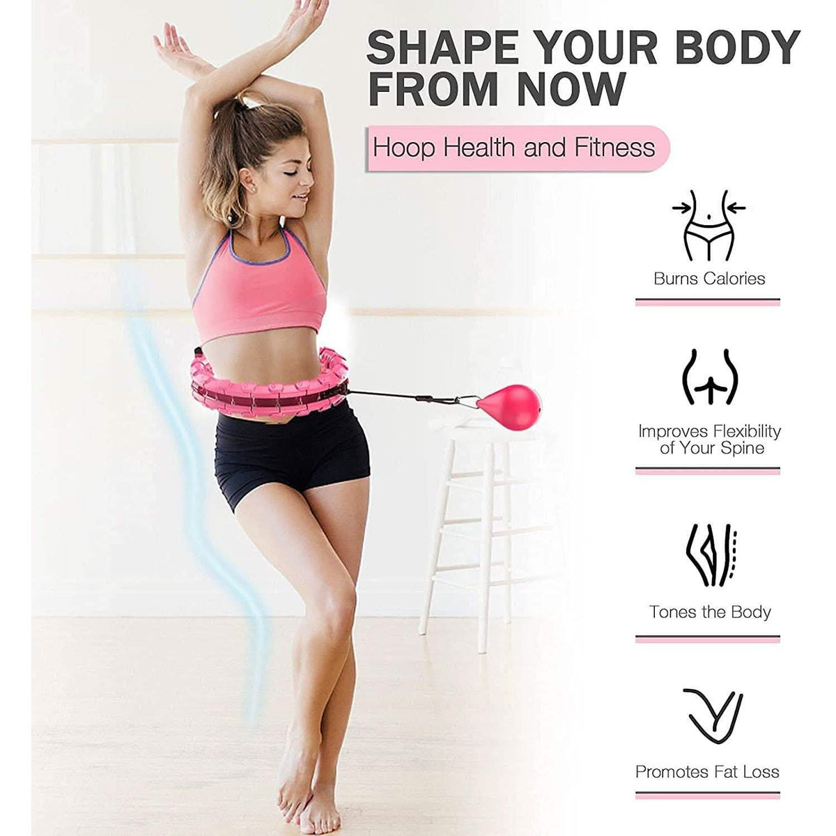 Pink weighted hula hoop being twirled around the waist during fitness exercise