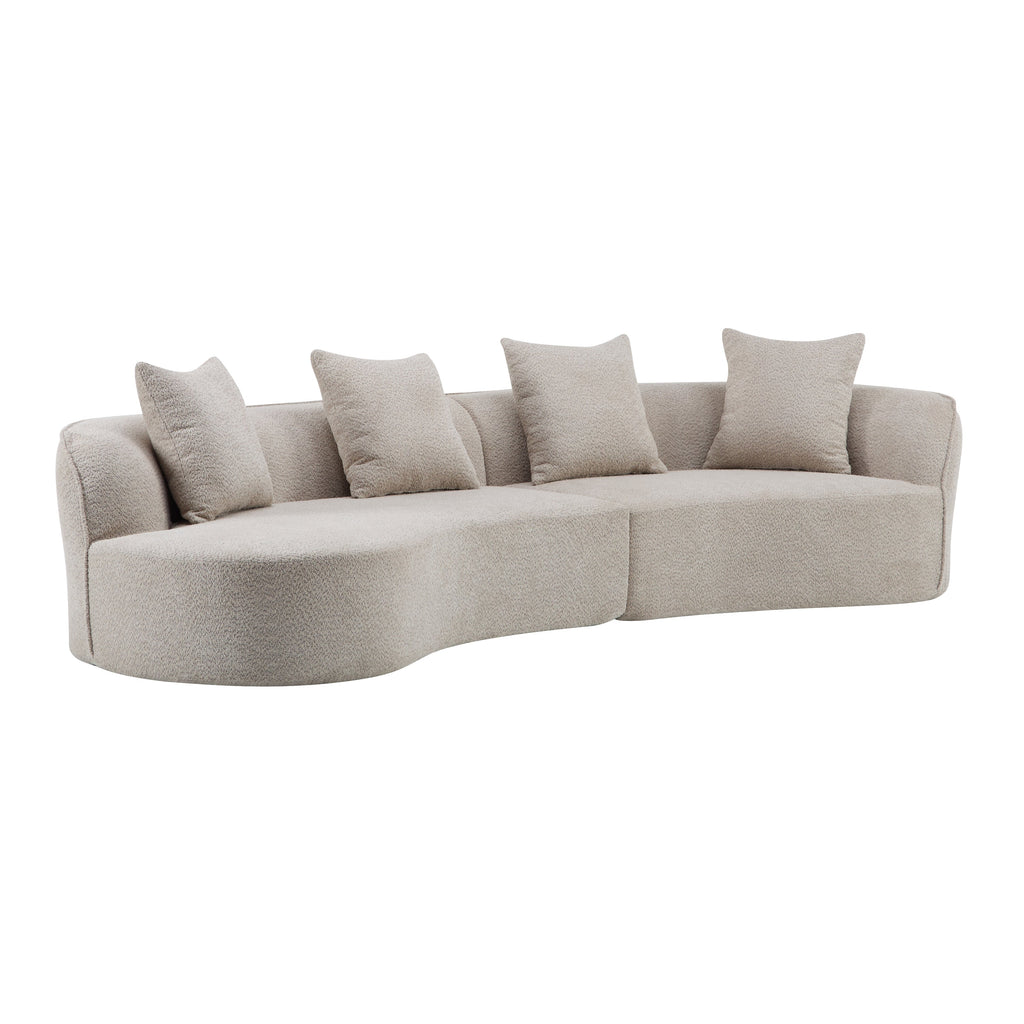 Light beige curved sectional sofa with four throw pillows and rounded chaise end