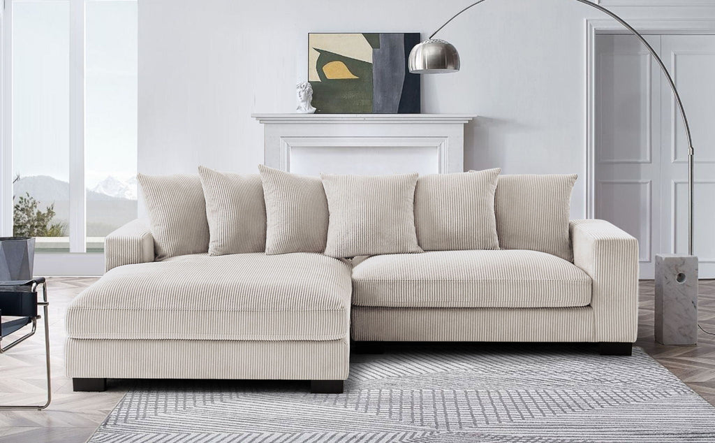L-shaped sectional sofa with chaise in light beige, upholstered cushions and armrests