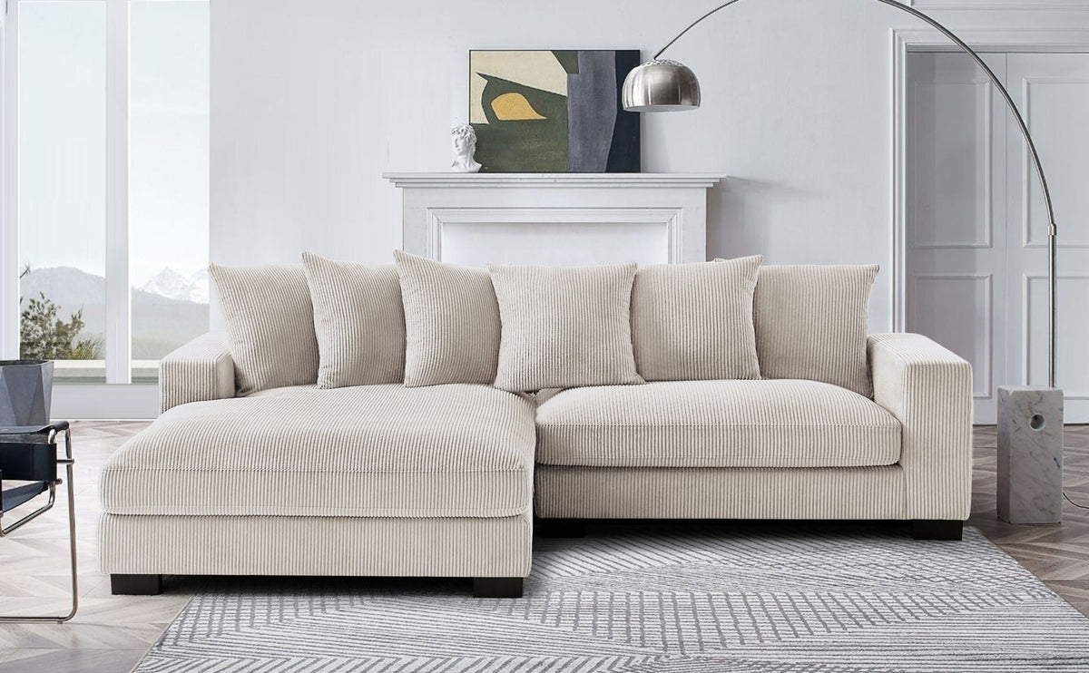 L-shaped sectional sofa with chaise in light beige, upholstered cushions and armrests