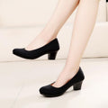 Women's black low-heel slip-on shoes with rounded toe and covered block heel