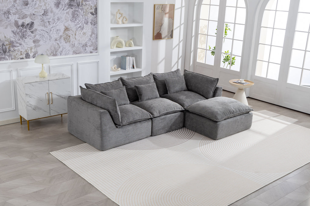 Gray modular sectional sofa with corner chaise and several matching throw pillows