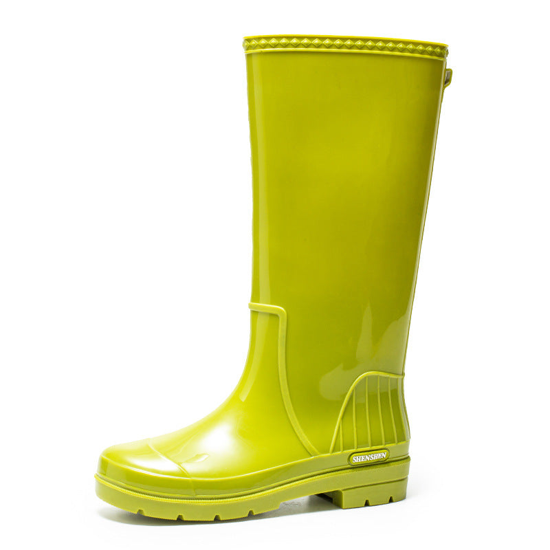 Bright yellow glossy high-top rain boot with thick tread sole