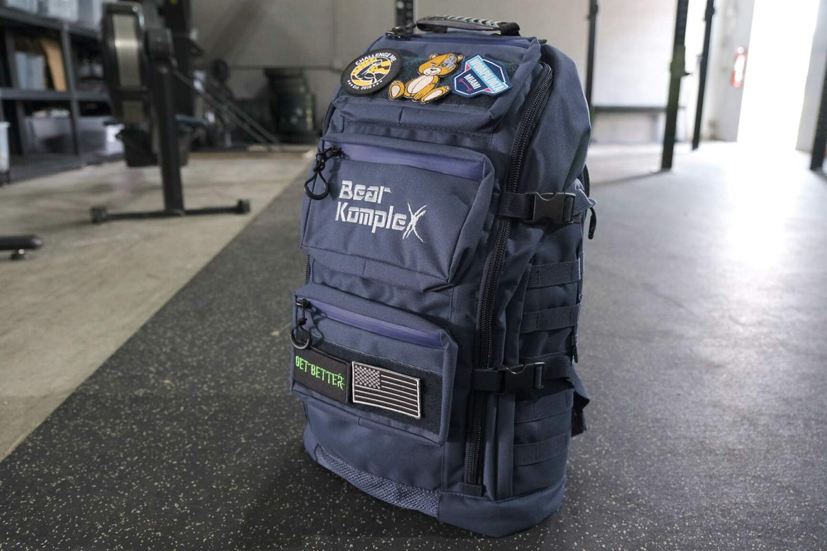 BKX navy blue military backpack angled view with side straps and front patch details