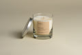 Luxury candle in clear glass jar with cream wax, gold wick cross, silver lid