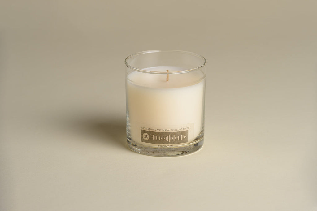 Luxury candle in clear glass jar with cream wax and front label