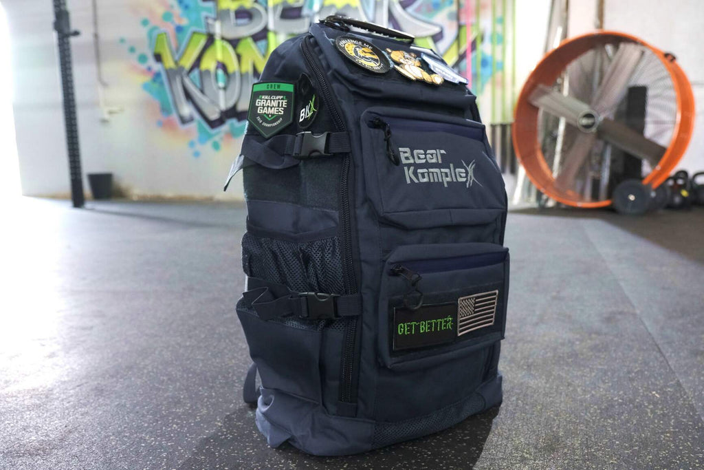 BKX black military backpack front view with front patch badges and organizer pocket