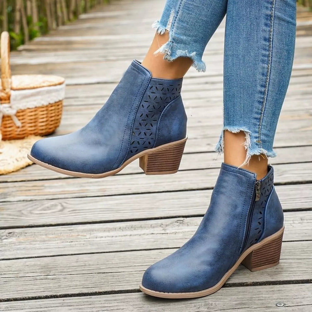Blue ankle boots with block heel, side cutout perforations, and pull-on ankle shaft