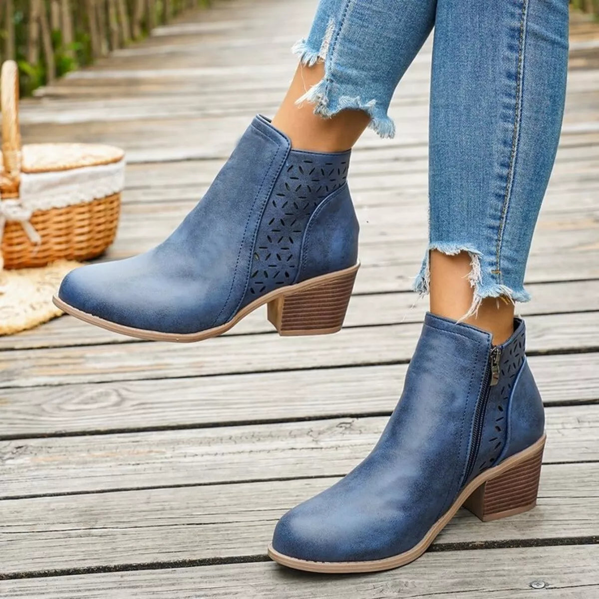 Blue ankle boots with block heel, side cutout perforations, and pull-on ankle shaft