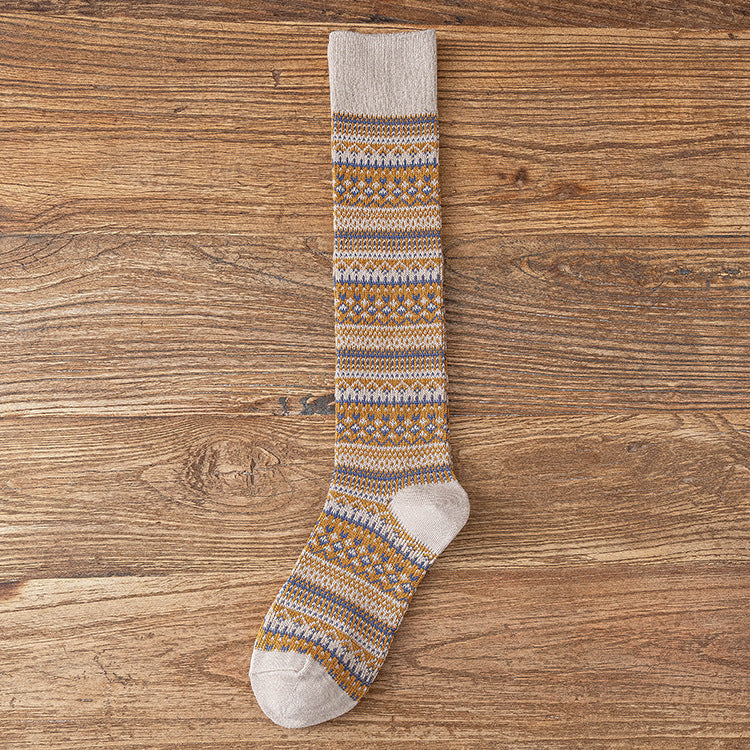 Children’s knee-length socks in light gray with orange and blue geometric stripe pattern.