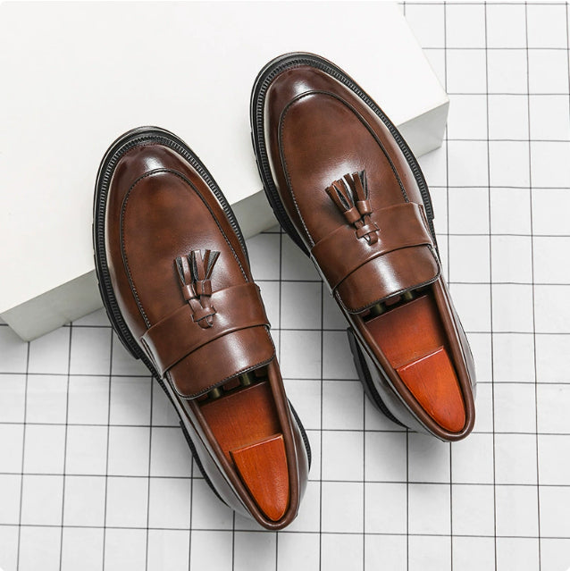Brown leather tassel loafers, pair view, with contrast topstitching