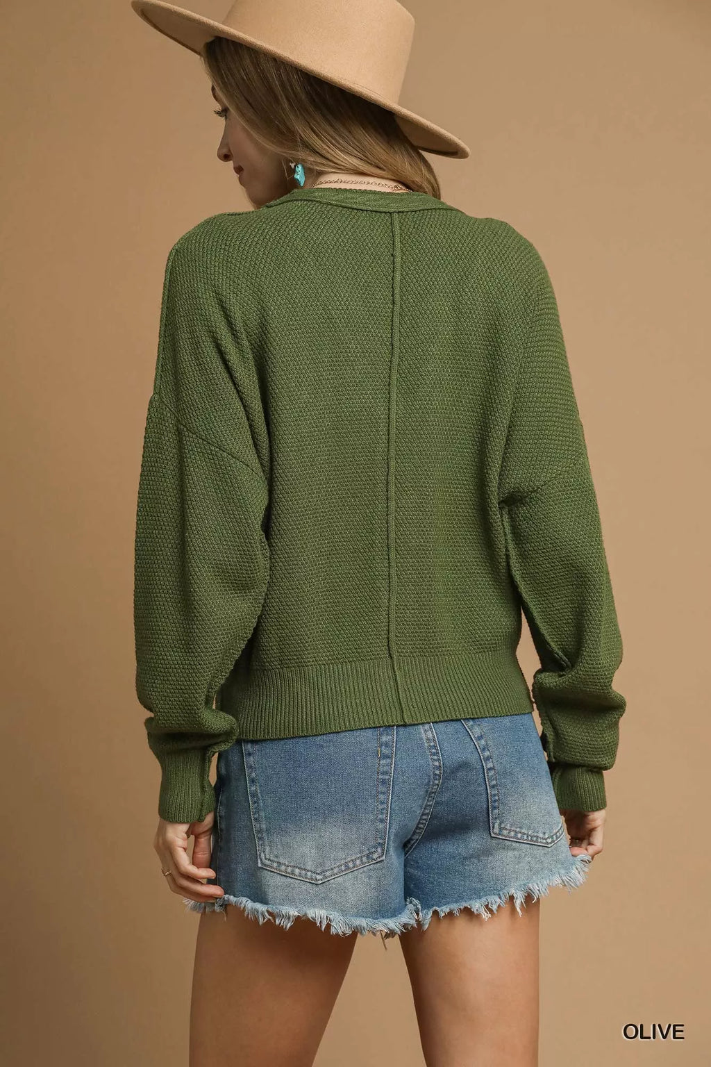 Olive cable-knit cardigan back view with long sleeves and button placket seam.