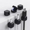 Set of 6 black magnetic cable clips with adhesive backing for managing charging cords