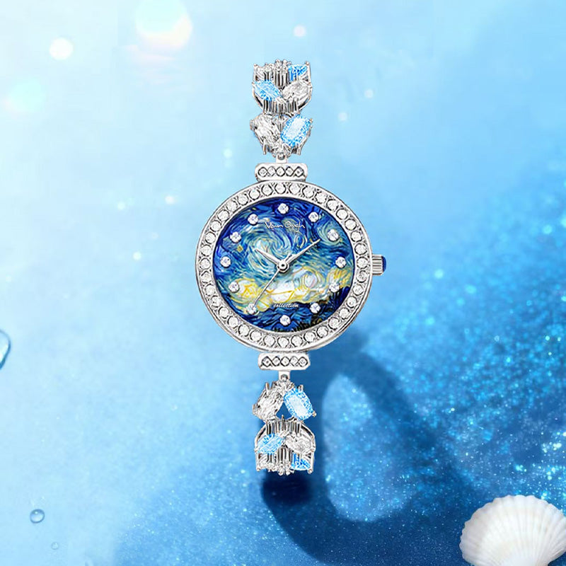 Blue floral face wristwatch with crystal accents on bezel and charm-style links
