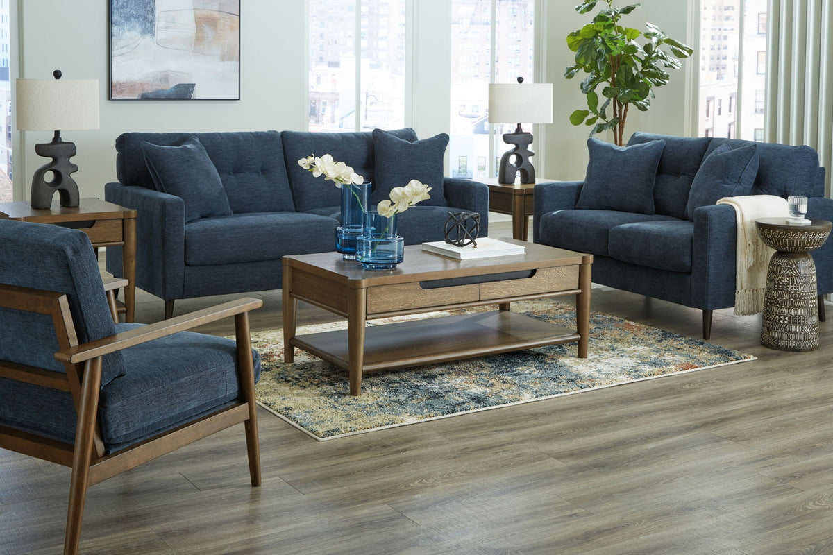 Blue fabric sofa and loveseat set with tufted back cushions and tapered legs