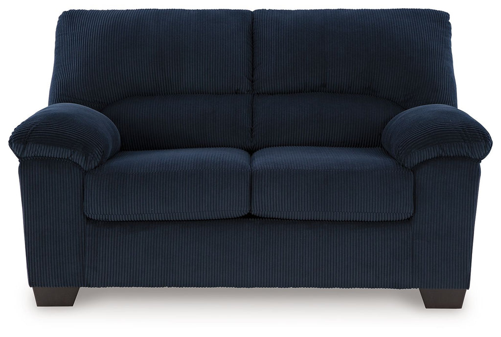 Upholstered loveseat in blue fabric with rolled arms and two-seat tufted cushion