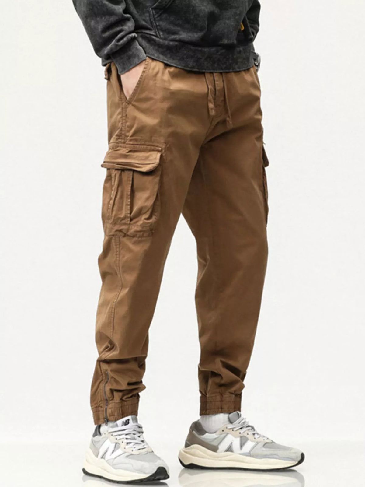 Men's casual cargo pants in tan brown with drawstring waist and cargo pocket panels