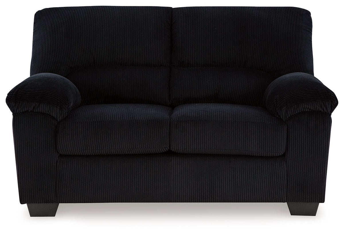 Upholstered loveseat in dark fabric with rolled arms, tufted back, and two seat cushions