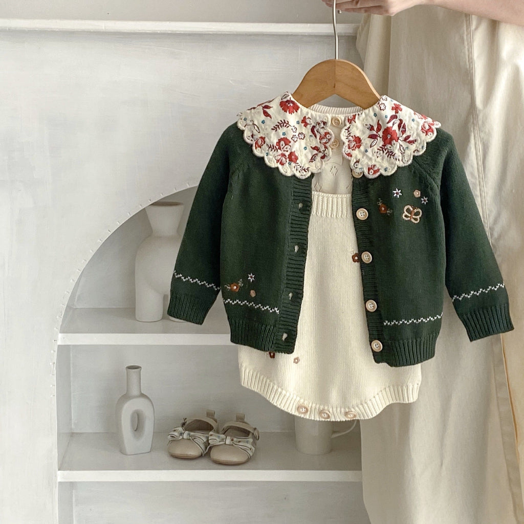 Infant dark green cardigan with red floral collar over cream knit romper with button placket