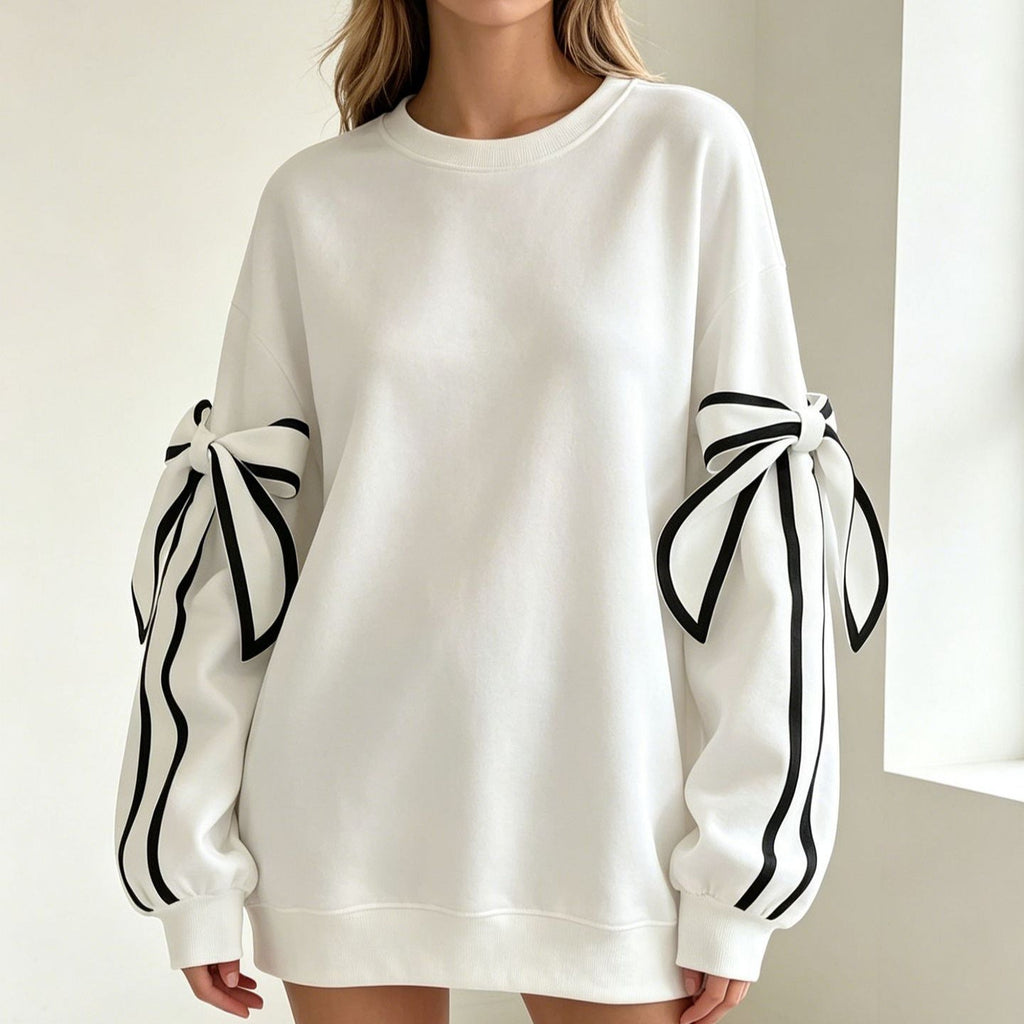 White crewneck long-sleeve sweater featuring black striped bow details at both cuffs.
