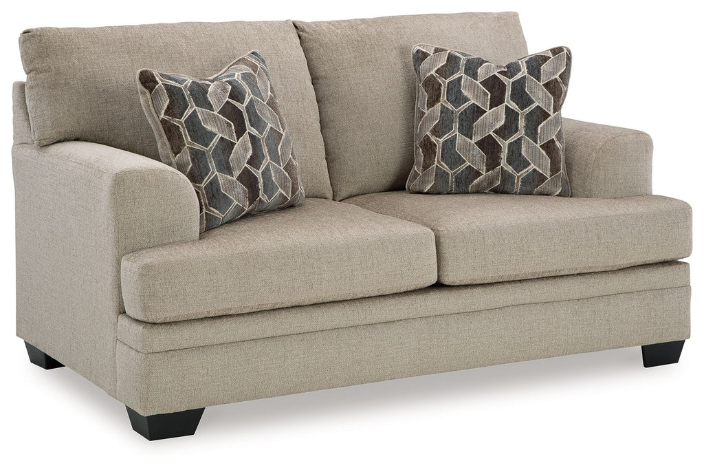 Light beige loveseat with two seat cushions, rolled arms, and geometric throw pillows